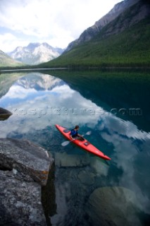 Andy Feuling paddles his kayak alone on Bowman Lake in Glacier National Park, Montana.