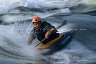 Paddling in churning whitewater at the reversing falls, which are caused by tidal flows, on the Sheepscot River in Alna.