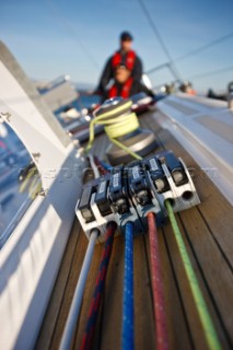 A  closeup shot of lines and line stoppers on the deck of  the Swan 48 sloop, COLIBRI, with Sean Broe (upper) and Anton Muzik (lower) in the background, sailing on the waters of San Francisco Bay on October 21, 2008.