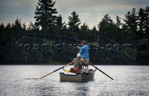 Fly Fisherman casting his fly in the rain on the Flambeau River