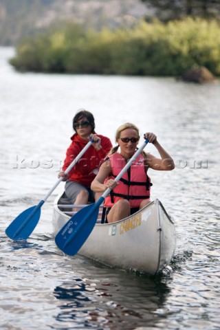 Two young women canoeing at Silver Lake near Kirkwood Mountain Resort California