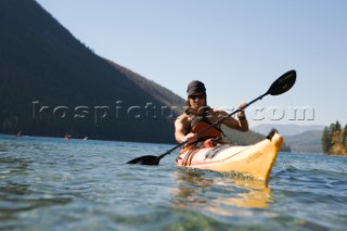 Man kayaking Kintla Lake during two day backpack loop trip through heart of Glacier National Park, MT near Hole-in-the-Wall area -  Greg Franson.