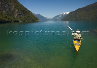 Chris Spelius sea kayaks in Lago Yelcho, Chile.