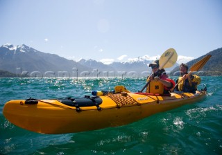 Marika Powers and Mike Powers kayak during a wilderness adventure in Lago Yelcho, Chile.