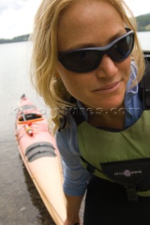 Woman finishing sea kayaking NW Montanas Dickey lake - Karin Sundstrom.