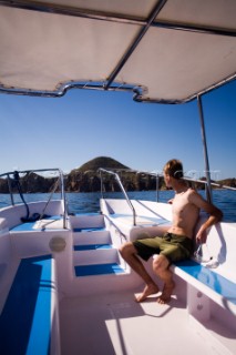 A man rides on a tour boat in Cabo San Lucas, Mexico  (releasecode: 20071103-SamWells.jpg)