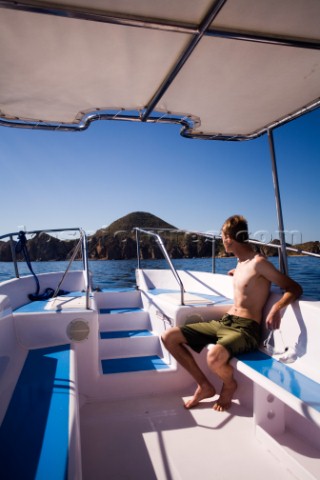 A man rides on a tour boat in Cabo San Lucas Mexico  releasecode 20071103SamWellsjpg 
