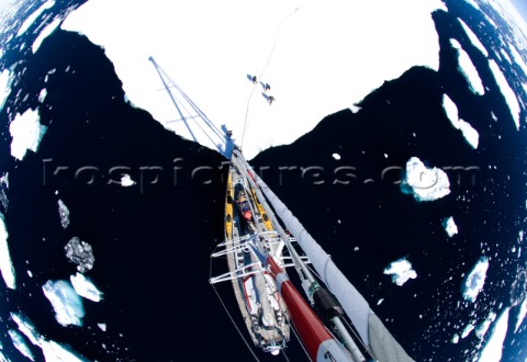 A sailboat anchors on an ice sheet while its crew explores Located in  the west coast of Antarcticas