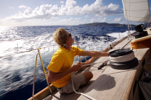 A crewmate tightens a line onboard the WClass yacht Wild Horses St Bartholomew French West Indies re