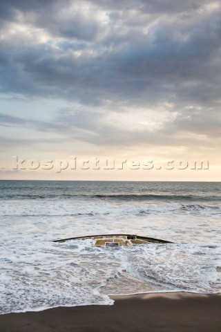 The remains of a sailboat the  Culin gets battered by waves on the Pacific coast of Mexico  The sail