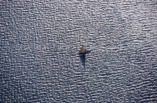Aerial view of a fishing dhow sailing in shallow water near Kiwayu island off the northern coast of Kenya.