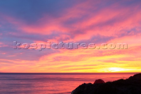 Tent on the bluffs above the central California coast during pink sunset