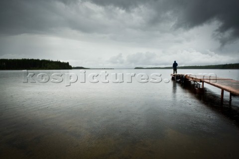 A man stands on the pier on Gregoire Lake Without the huge amount of fresh water resources in Northe