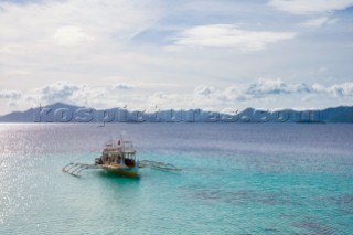 Outrigger boat anchored at Cauayan Island (Bulalacao Island), Coron, Palawan, Philippines