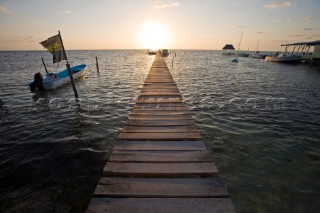Belize, Central America - Sunrise at one of the many private, wooden piers on the Caye Caulker waterfront.