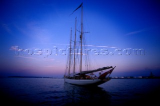 A classic yacht rests at anchor in the calm evening hours, Casco Bay, Portland, Maine. Peter Dennen/Aurora Photos/Kos Pictures