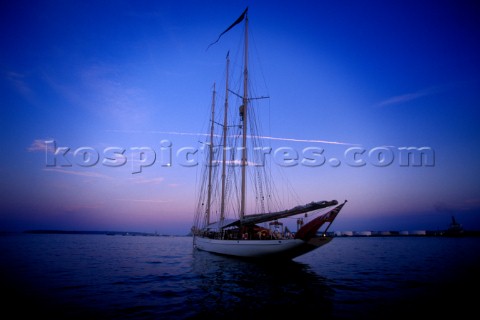 A classic yacht rests at anchor in the calm evening hours Casco Bay Portland Maine Peter DennenAuror